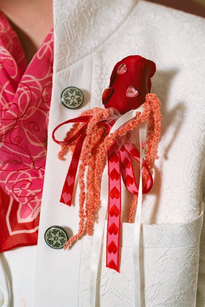 A close up of a rose boutonniere is photographed at an Alabama elopement  