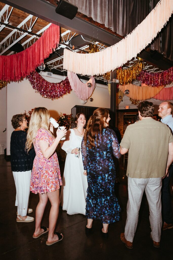 The Sage indoor-outdoor Birmingham Venue reception with guests dancing under disco balls