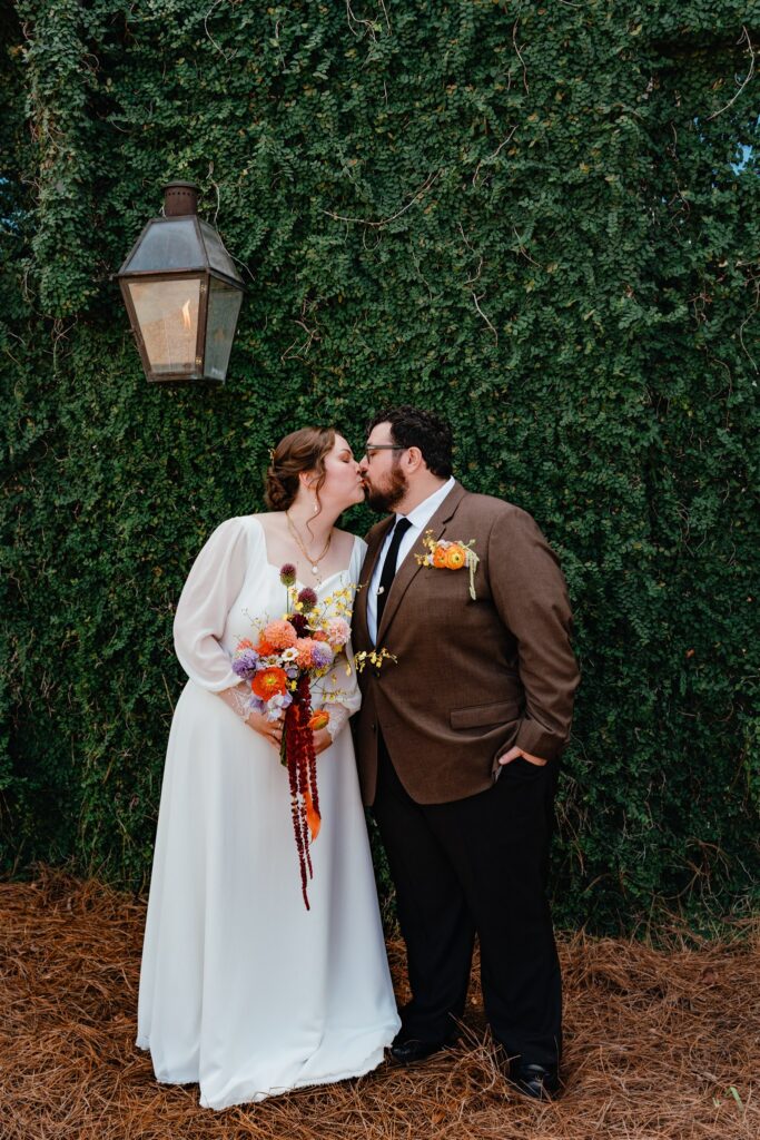 Newlyweds share a kiss following their Alabama wedding reception at The Sage 