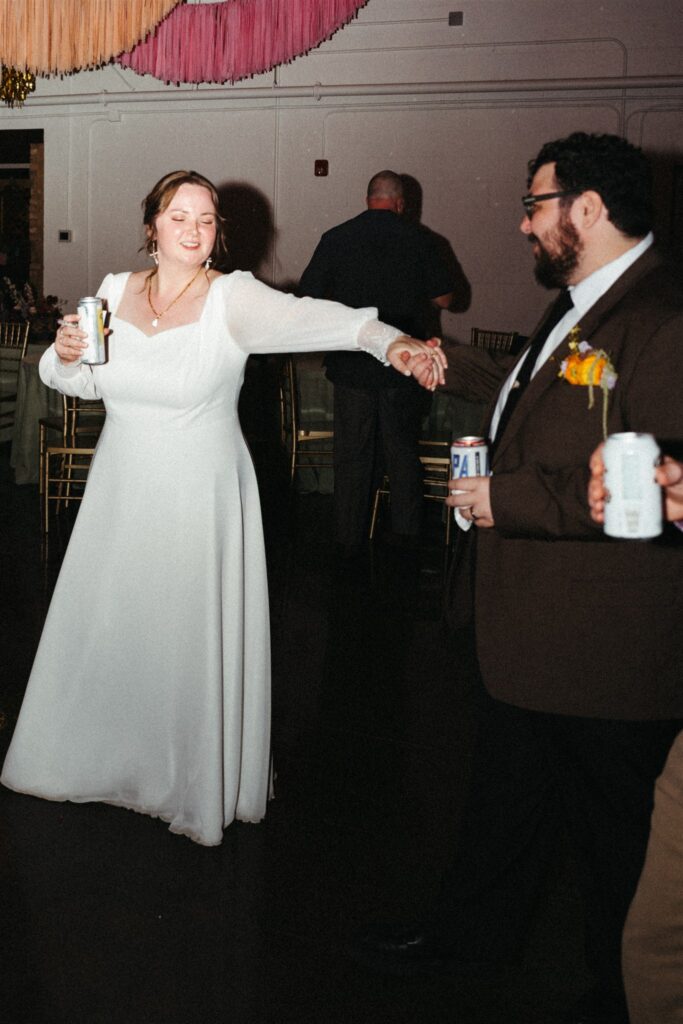 A bride and groom share a dance at their colorful reception held at a Birmingham venue