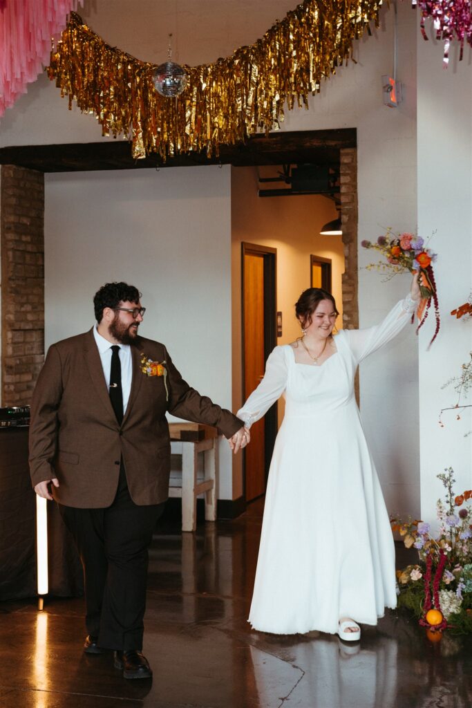 A bride & groom celebrate at their reception held at a downtown Birmingham venue 