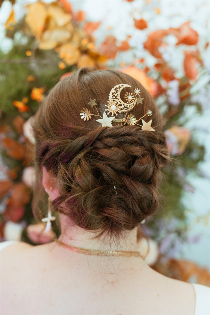 A celestial bridal hair comb by Mignonne Handmade is photographed at a Birmingham AL wedding reception 