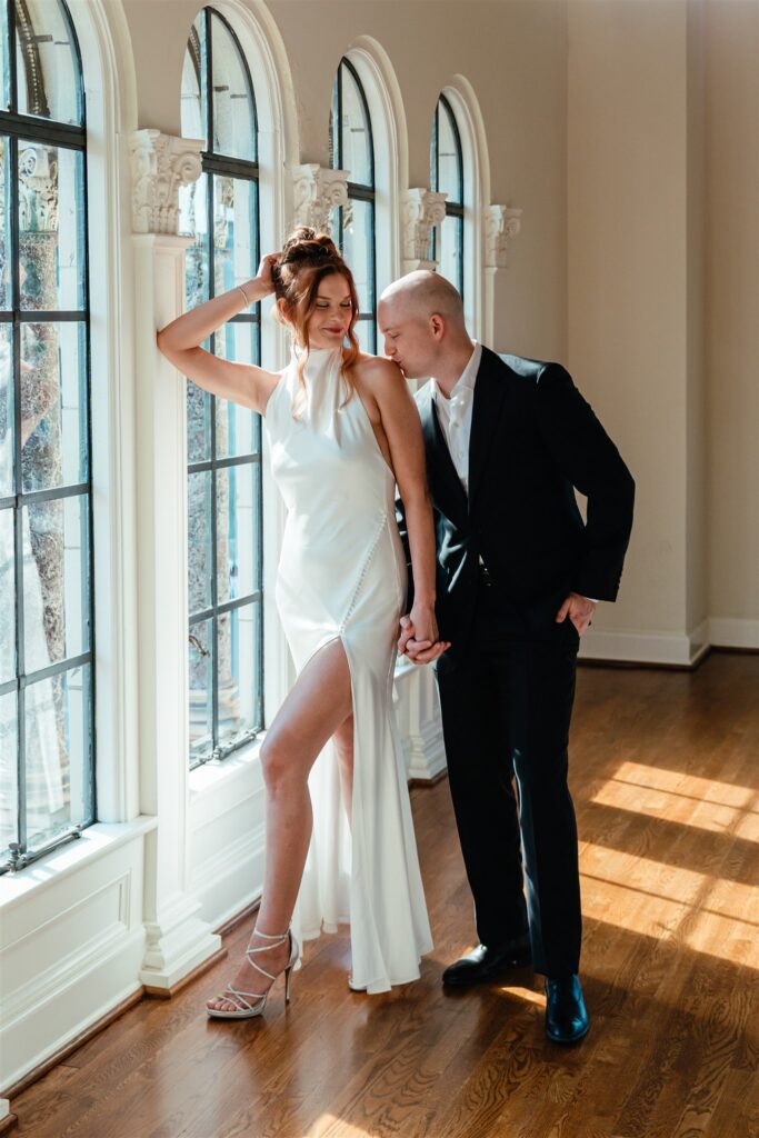 A bridal portrait shows a groom being affectionate with his bride at their reception held at The Florentine Birmingham