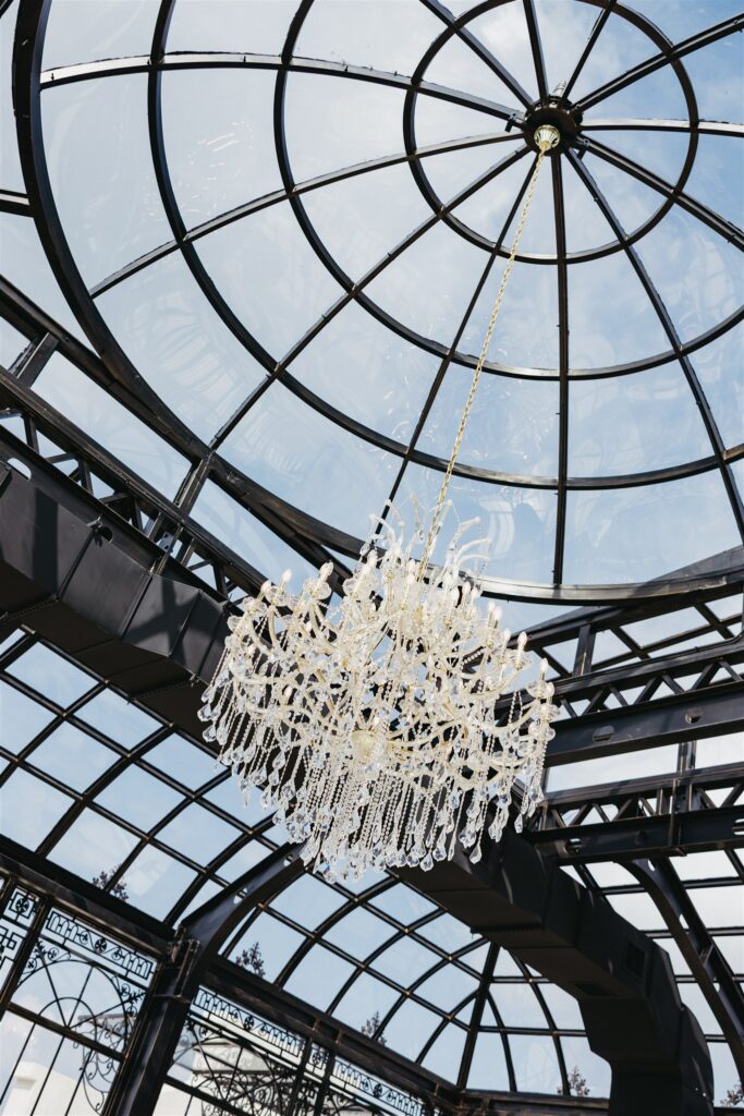 The chandelier inside the atrium is photographed at a stone haven wedding 