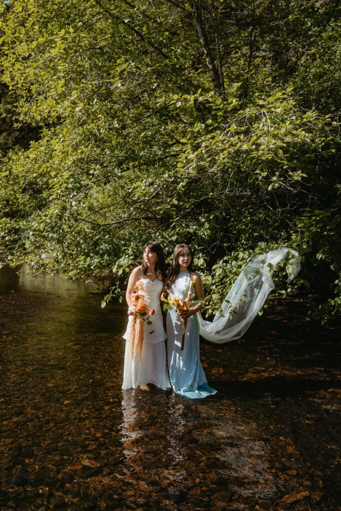 Porttland Oregon elopement brides lying on a floral rug surrounded by fruit and greener