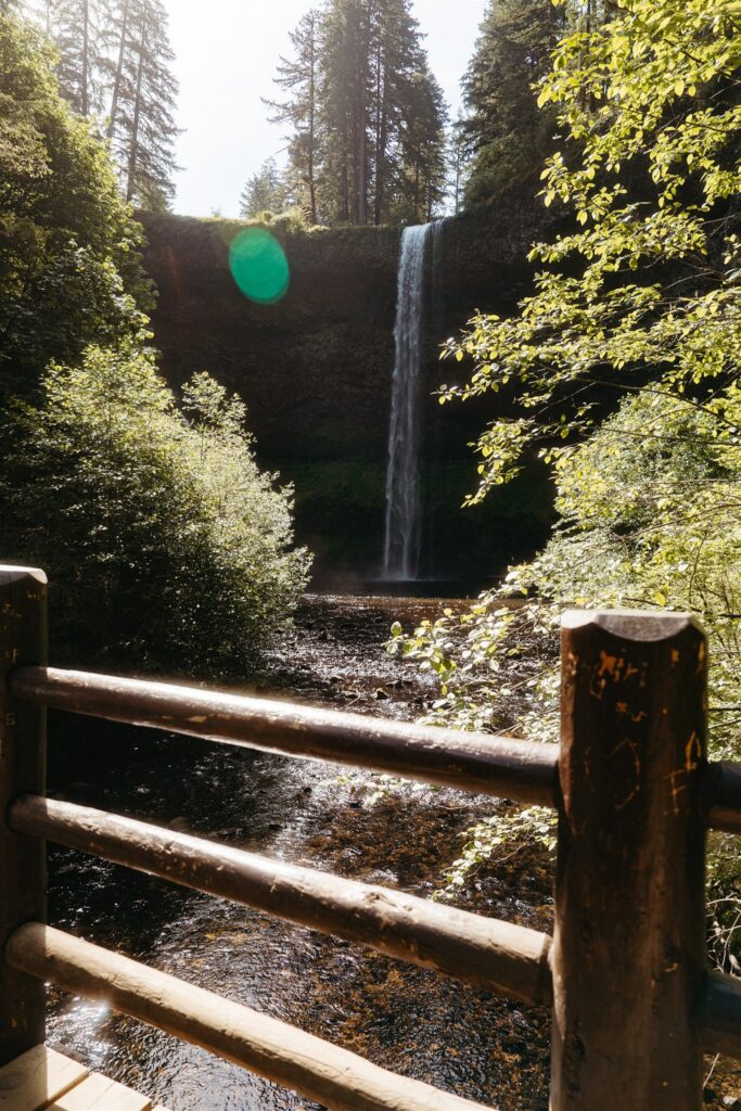 A waterfall at Silver Falls is photographed at a golden hour Portland Oregon elopement