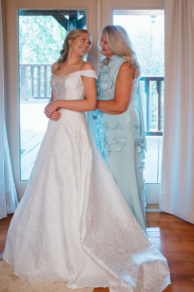 The mother of the bride assists her daughter with her dress before eloping in Pigeon Forge Tennessee. 