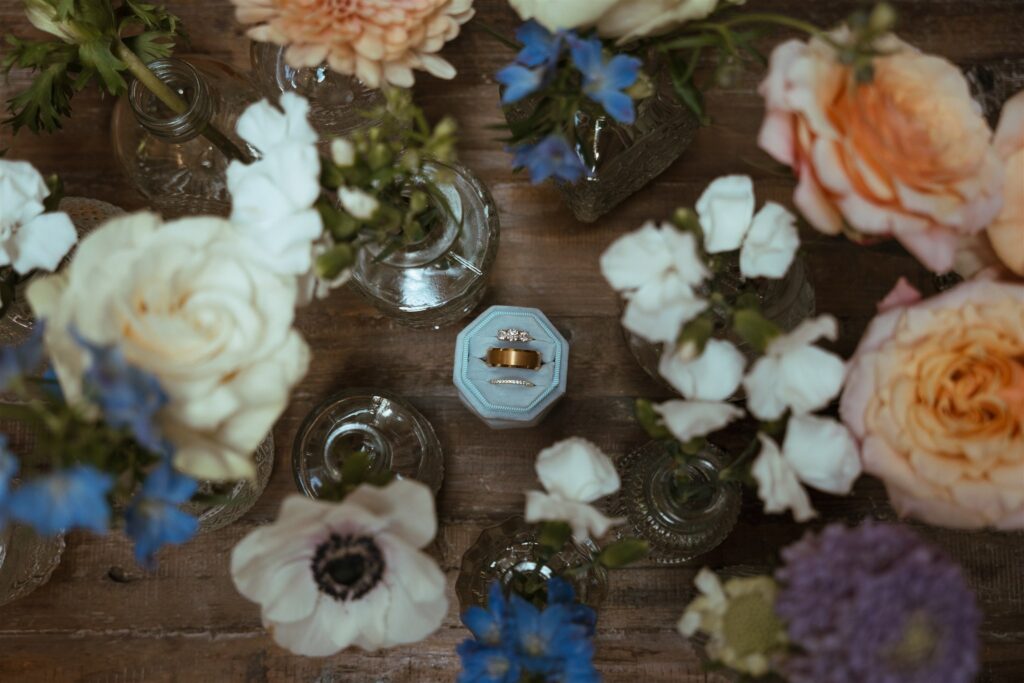 Pigeon Forge elopement details including florals and rings are photographed from above. 