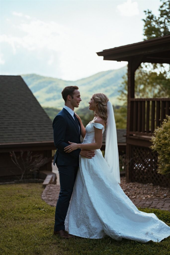 A couple eloping in Pigeon Forge Tennessee pose for a portrait in their wedding attire after their outdoor ceremony.