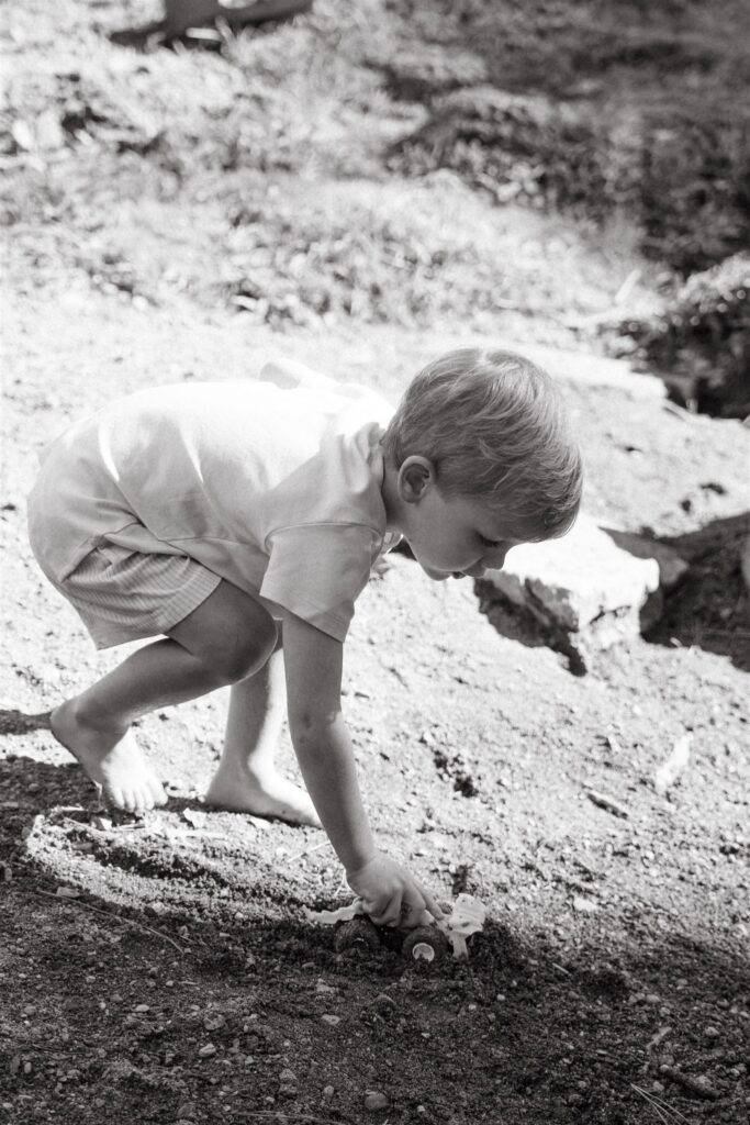 A young boy drives his toy monster truck through the dirt at a park during family photos in Birmingham, AL. 