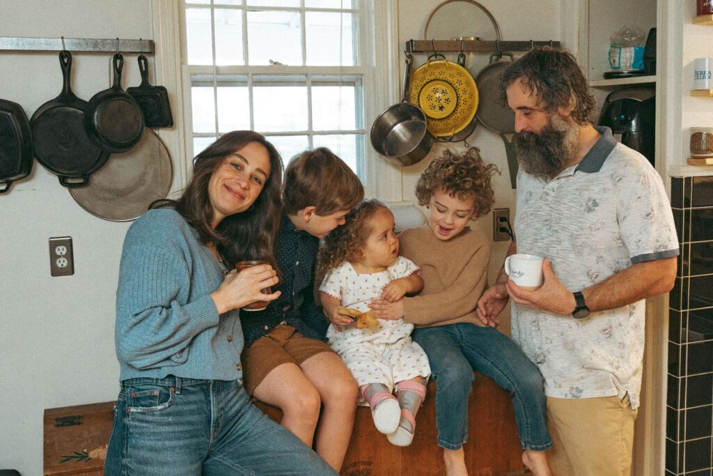 A family of 5 is photographed in their kitchen during an in-home family photoshoot in Birmingham.